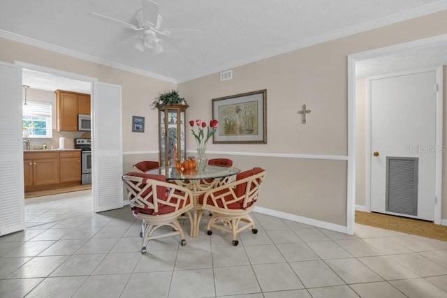 4262 Lake Underhill Rd Unit 9C7, Orlando, FL 32803 - dining space featuring crown molding, ceiling fan, baseboards, and light tile patterned flooring