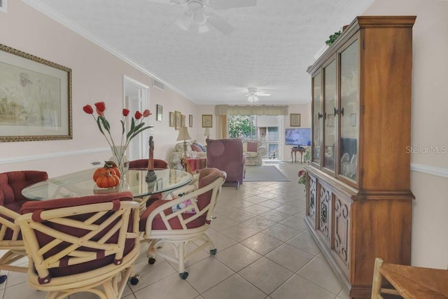 4262 Lake Underhill Rd Unit 9C7, Orlando, FL 32803 - dining area with a ceiling fan, light tile patterned flooring, and a textured ceiling