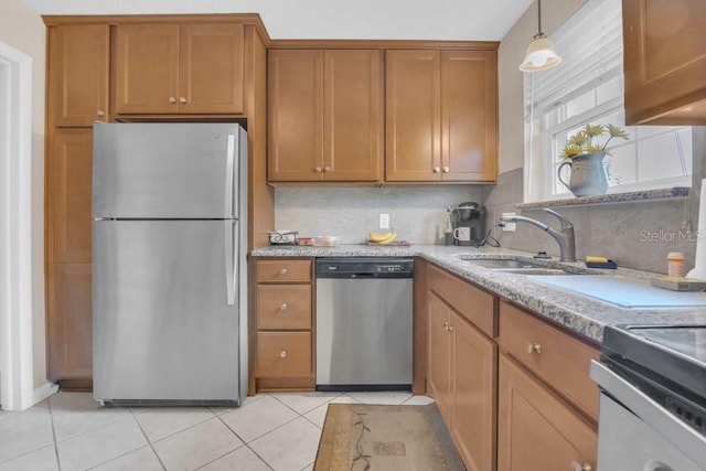 4262 Lake Underhill Rd Unit 9C7, Orlando, FL 32803 - kitchen with appliances with stainless steel finishes, a sink, brown cabinets, and light tile patterned floors