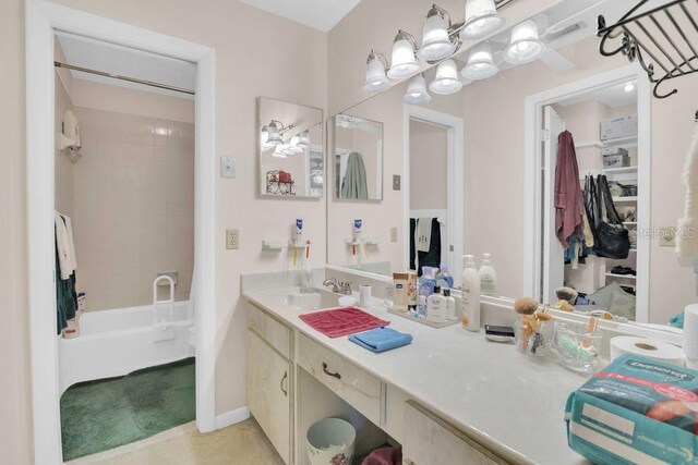 4262 Lake Underhill Rd Unit 9C7, Orlando, FL 32803 - bathroom with vanity, washtub / shower combination, and baseboards
