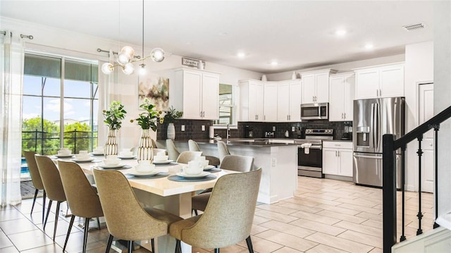 dining area with recessed lighting, stairs, a notable chandelier, and visible vents