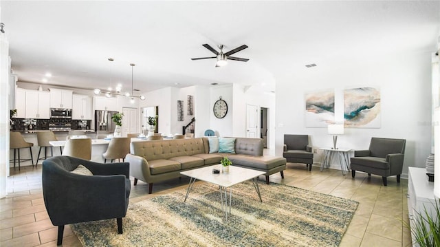 living room with ceiling fan, recessed lighting, and visible vents