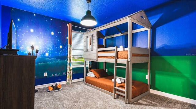 carpeted bedroom featuring baseboards and wallpapered walls