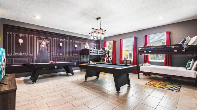 game room featuring pool table and a textured ceiling