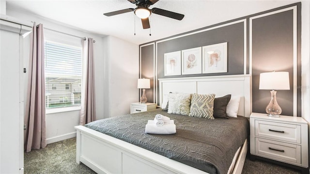 carpeted bedroom with a ceiling fan and baseboards