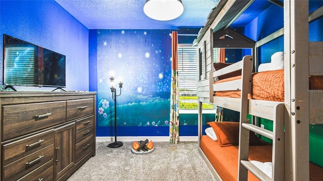 bedroom featuring baseboards, carpet flooring, and a textured ceiling