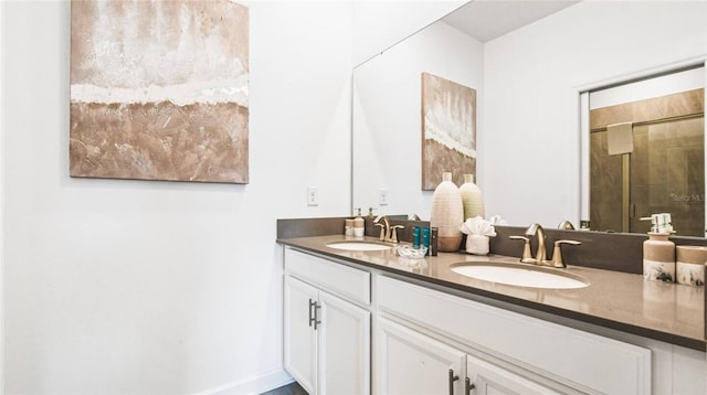 full bath with double vanity, a sink, and a tile shower
