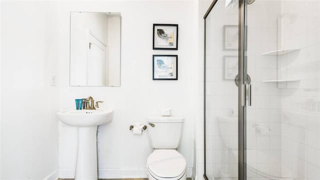 full bathroom with a stall shower and toilet