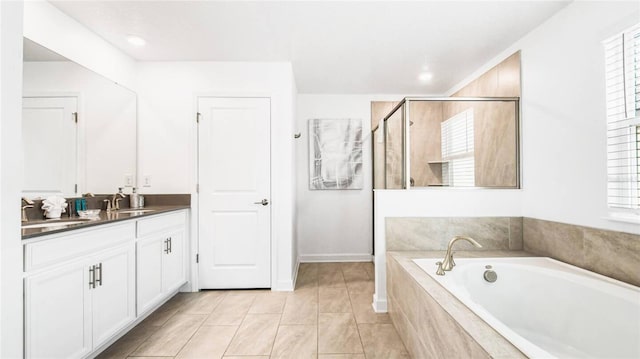 full bathroom featuring vanity, a stall shower, tile patterned floors, and a garden tub