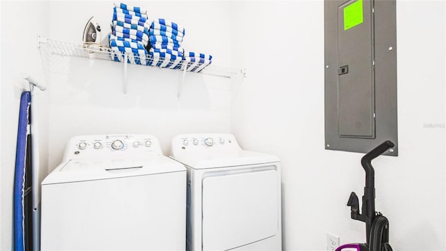 laundry room featuring electric panel, laundry area, and washer and dryer
