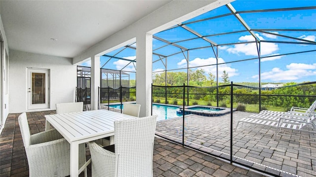 view of patio with a lanai and a pool with connected hot tub