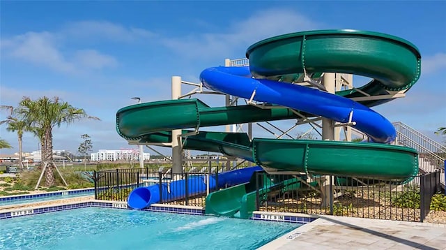 exterior space with fence and a swimming pool