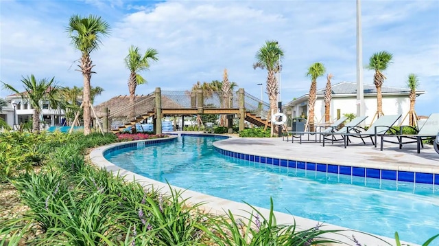 community pool featuring stairs and a patio area