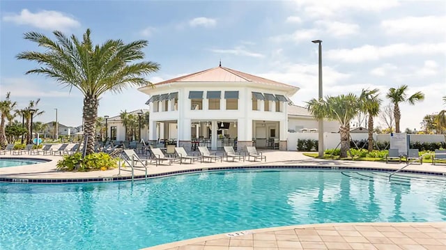 community pool with a patio area