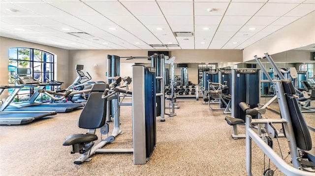exercise room with recessed lighting and a drop ceiling