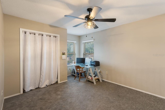 office with a ceiling fan, baseboards, and carpet flooring