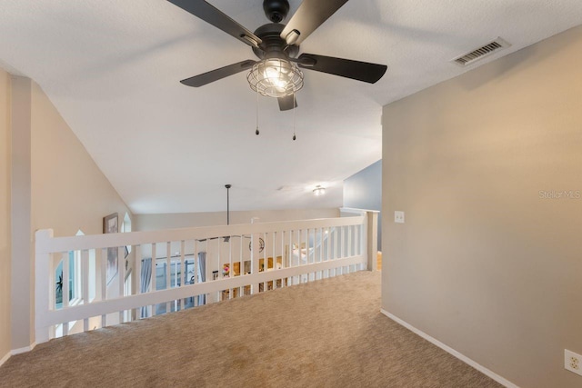 hallway with baseboards, carpet flooring, and visible vents