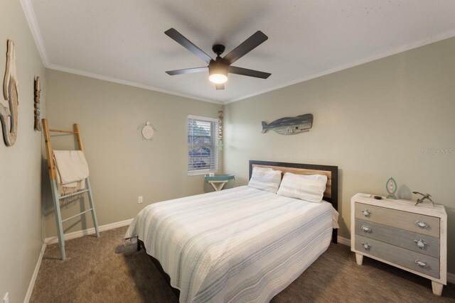 bedroom with crown molding, dark colored carpet, baseboards, and a ceiling fan