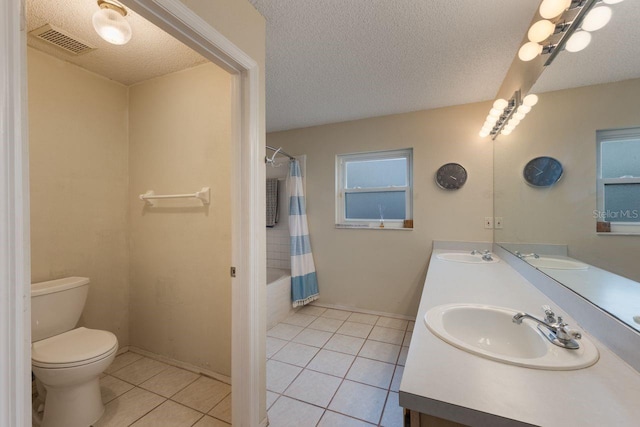 bathroom featuring a sink, toilet, visible vents, and tile patterned floors