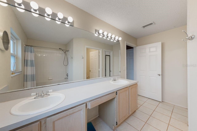 full bathroom with a shower with shower curtain, visible vents, tile patterned flooring, and a sink