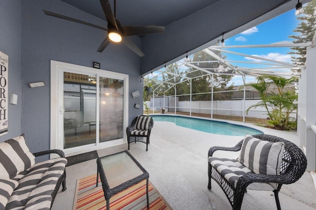 view of pool with a ceiling fan, a fenced in pool, fence, a patio area, and glass enclosure