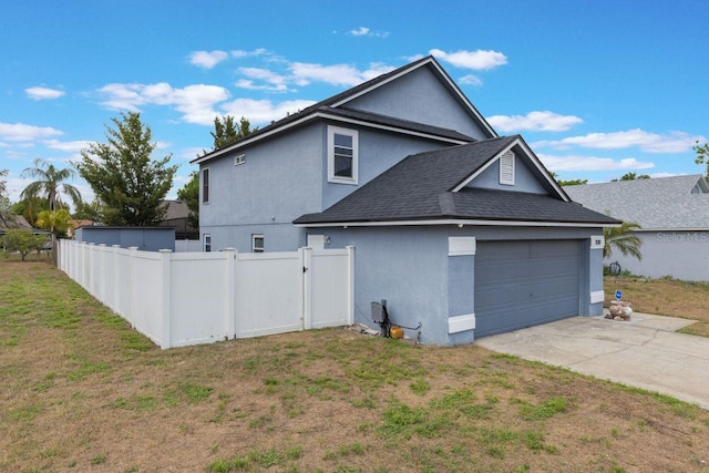 exterior space featuring stucco siding, driveway, fence, and roof with shingles