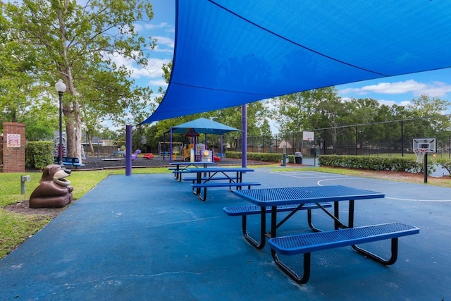 surrounding community featuring playground community, fence, and community basketball court