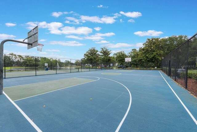 view of basketball court featuring fence and community basketball court