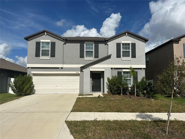 13344 Great Plains Dr S, Riverview, FL 33579 - traditional home with a garage, stucco siding, a front yard, and concrete driveway