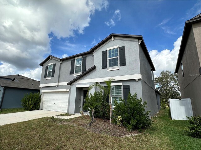 13344 Great Plains Dr S, Riverview, FL 33579 - traditional-style house with a garage, stucco siding, a front yard, and concrete driveway