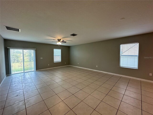 13344 Great Plains Dr S, Riverview, FL 33579 - empty room featuring baseboards, ceiling fan, visible vents, and light tile patterned floors