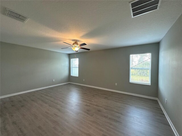 13344 Great Plains Dr S, Riverview, FL 33579 - unfurnished room featuring a ceiling fan, a textured ceiling, visible vents, and dark wood-type flooring