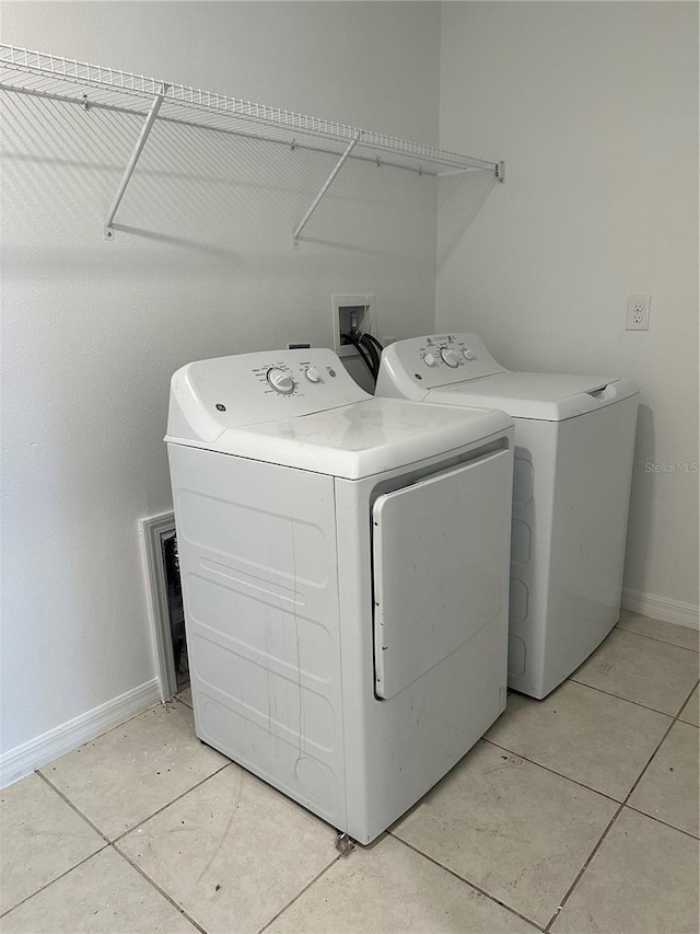 13344 Great Plains Dr S, Riverview, FL 33579 - washroom with laundry area, baseboards, light tile patterned floors, and washing machine and dryer