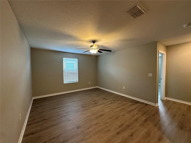13344 Great Plains Dr S, Riverview, FL 33579 - unfurnished room featuring visible vents, baseboards, ceiling fan, dark wood-style floors, and a textured ceiling