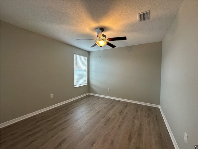 13344 Great Plains Dr S, Riverview, FL 33579 - spare room with ceiling fan, a textured ceiling, visible vents, baseboards, and dark wood-style floors