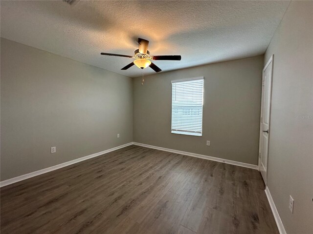 13344 Great Plains Dr S, Riverview, FL 33579 - unfurnished room featuring baseboards, ceiling fan, dark wood-style floors, and a textured ceiling