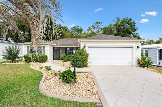 ranch-style home with concrete driveway, an attached garage, and a front yard