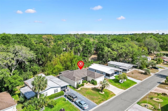drone / aerial view with a view of trees and a residential view