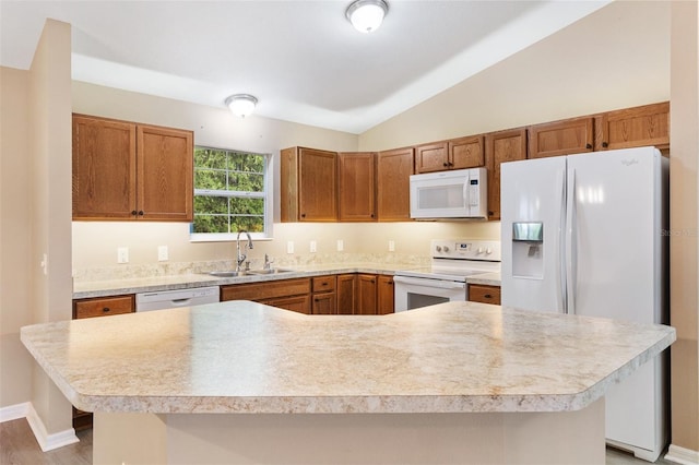kitchen featuring a sink, white appliances, light countertops, brown cabinetry, and lofted ceiling