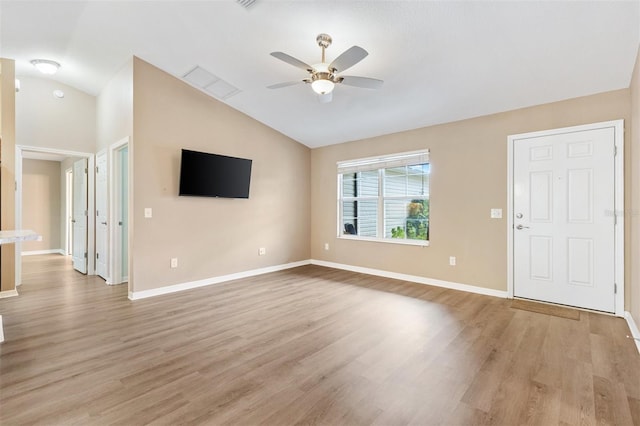 unfurnished living room featuring ceiling fan, vaulted ceiling, and light wood-style floors