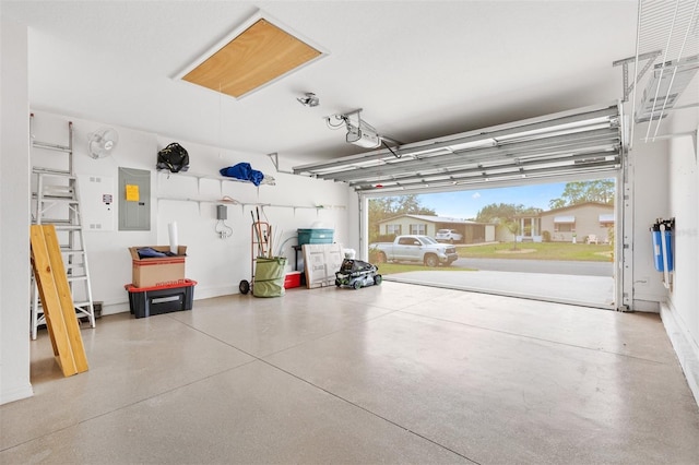 garage featuring a garage door opener and electric panel