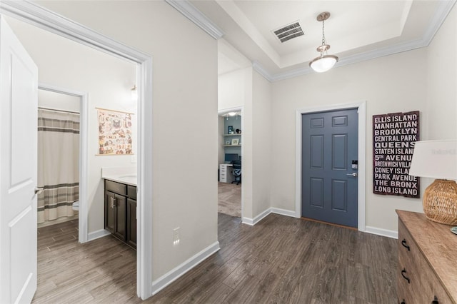 entrance foyer featuring baseboards, a tray ceiling, and dark wood-style floors