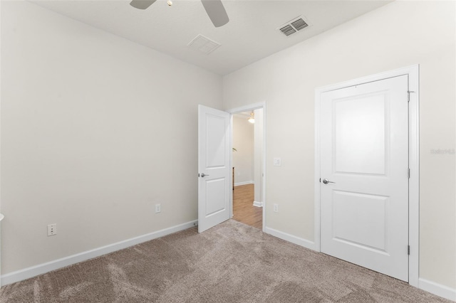 unfurnished bedroom featuring carpet flooring, baseboards, and visible vents