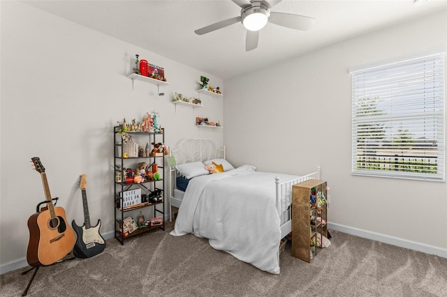 carpeted bedroom featuring baseboards and ceiling fan