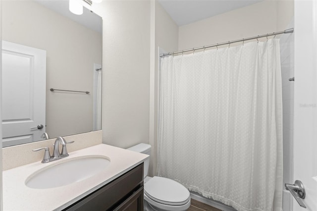 full bathroom with vanity, curtained shower, and toilet