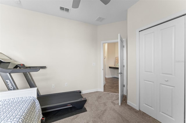 exercise area with baseboards, carpet, a ceiling fan, and visible vents