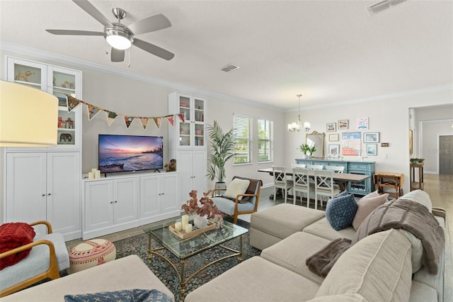 living room with crown molding, visible vents, and wood finished floors
