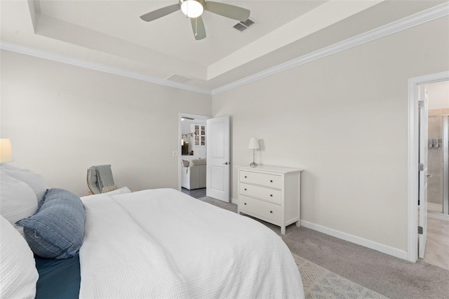 carpeted bedroom with a ceiling fan, visible vents, a raised ceiling, baseboards, and ornamental molding