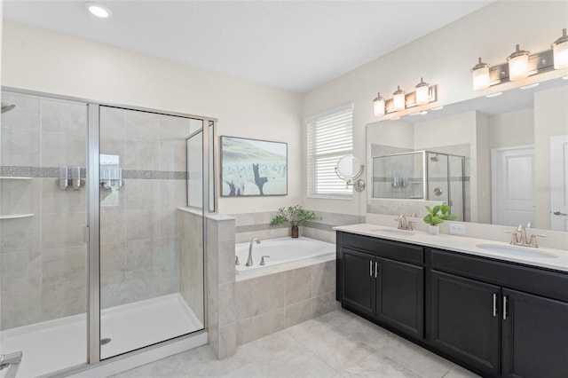full bath with tile patterned flooring, a shower stall, a sink, and a garden tub