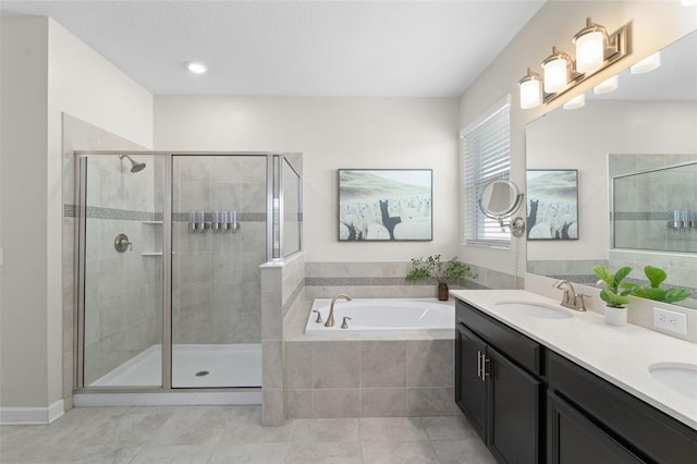 full bathroom with a garden tub, a sink, a stall shower, and tile patterned floors